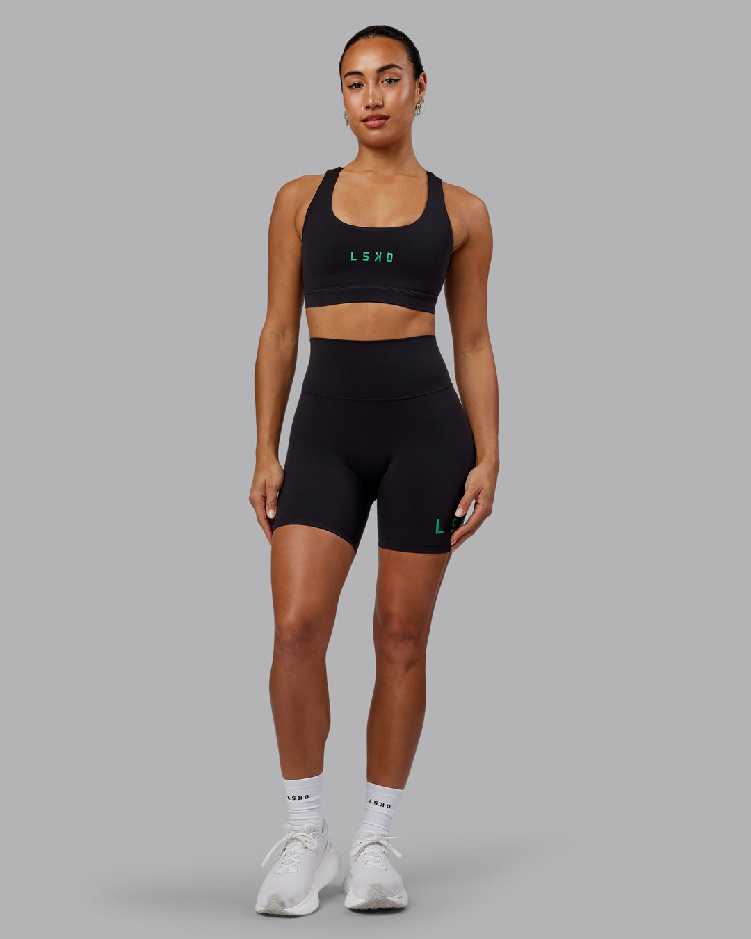 Woman wearing Rep Sports Bra - Black-Impact Green - view 5