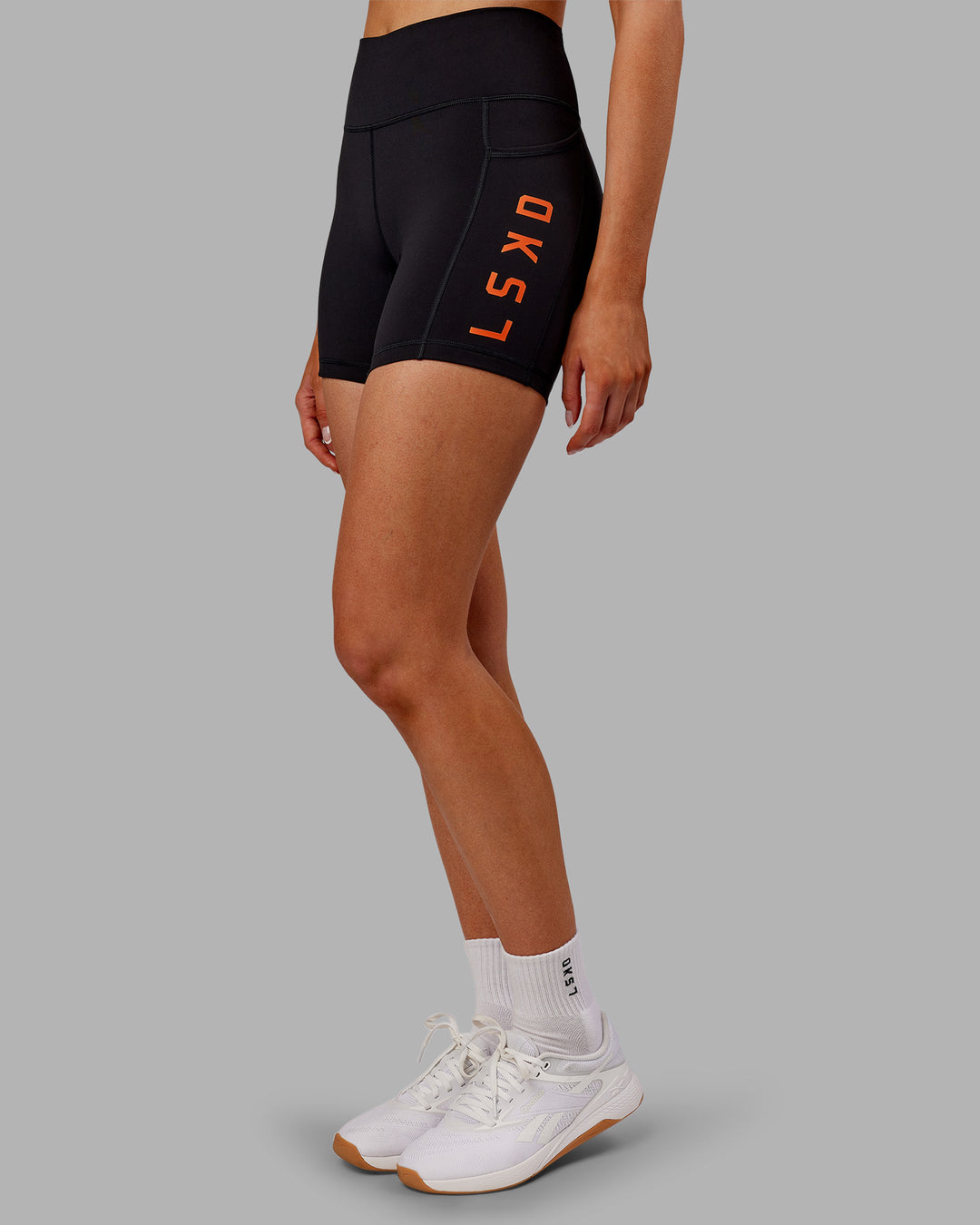 Woman wearing Rep Ultra High-Rise 4" Short Pockets - Black-Ultra Orange | Model:Ella | Size:S - view 2