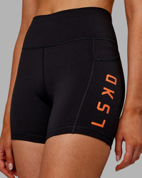 Woman wearing Rep Ultra High-Rise 4" Short Pockets - Black-Ultra Orange | Model:Ella | Size:S | Thumbnail Index: 6