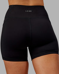 Woman wearing Rep Ultra High-Rise 4" Short Pockets - Black-Ultra Orange | Model:Ella | Size:S | Thumbnail Index: 8
