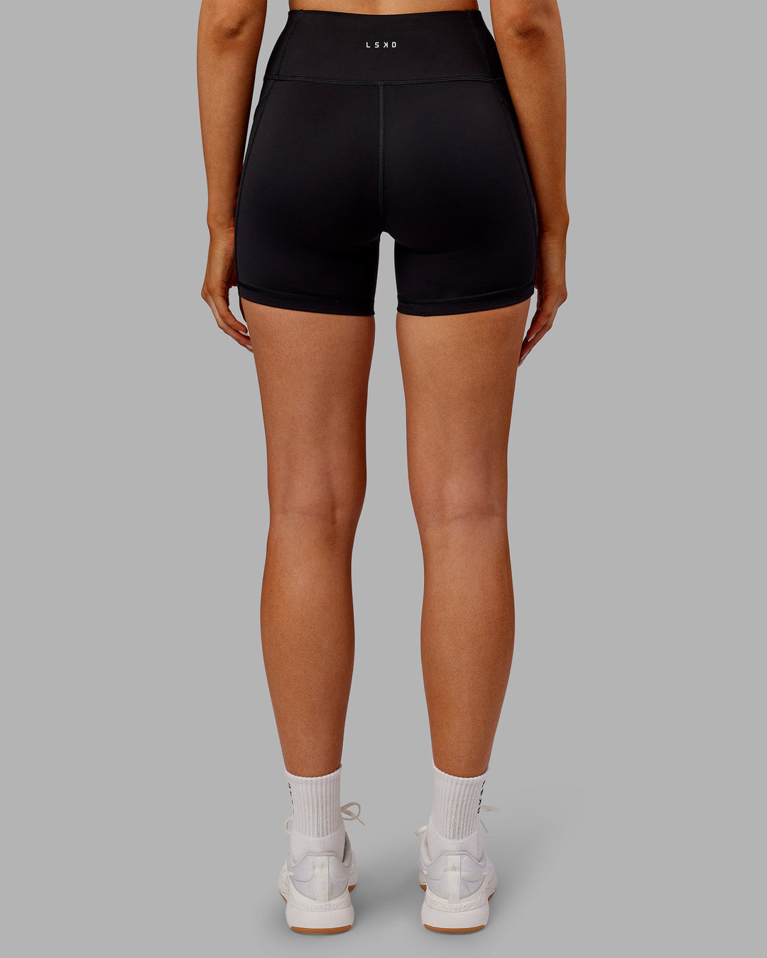 Woman wearing Rep Ultra High-Rise 4" Short Pockets - Black-Ultra Orange | Model:Ella | Size:S - view 4