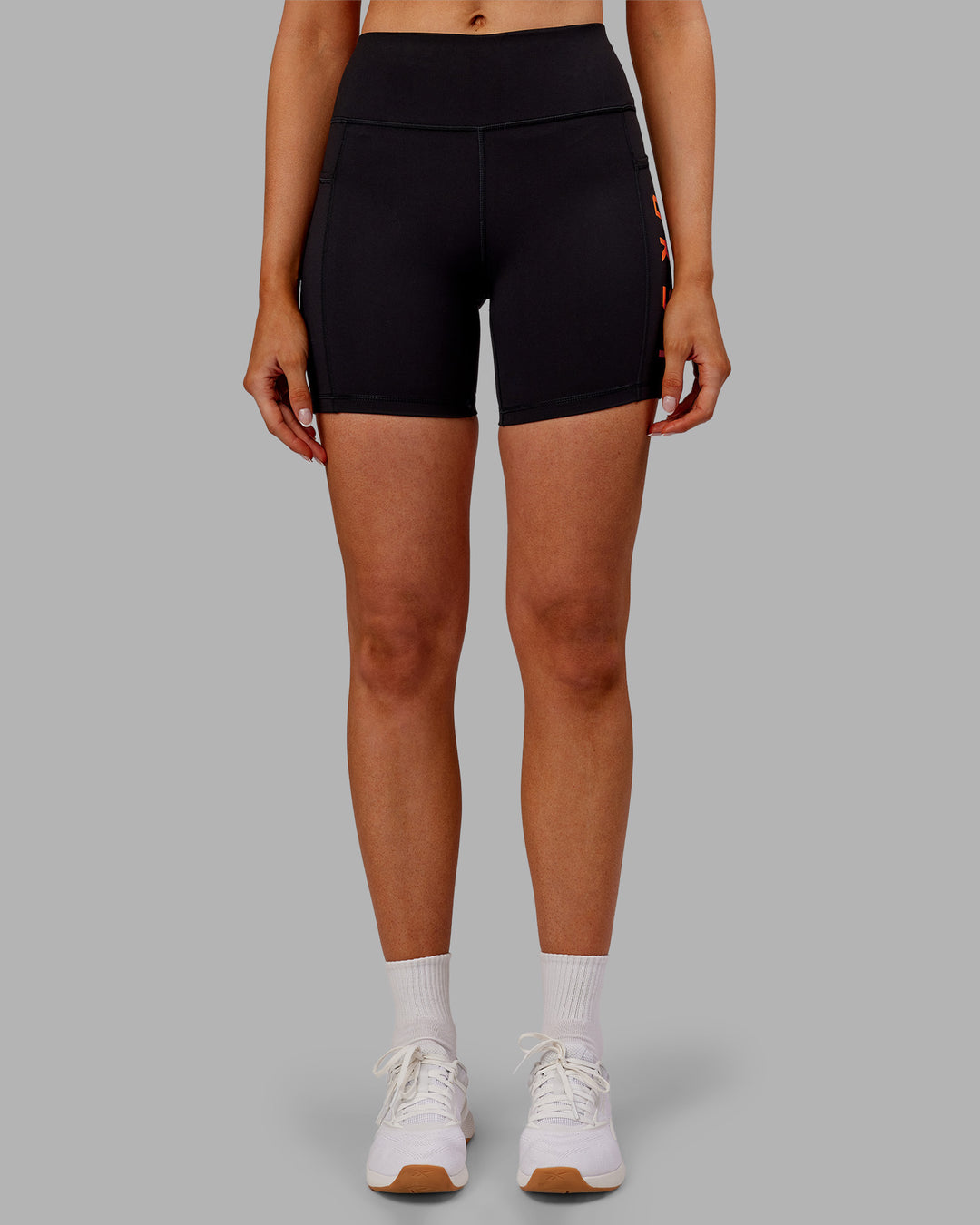 Woman wearing Rep Ultra High-Rise 6" Short Pockets - Black-Ultra Orange | Model:Ella | Size:S - view 7