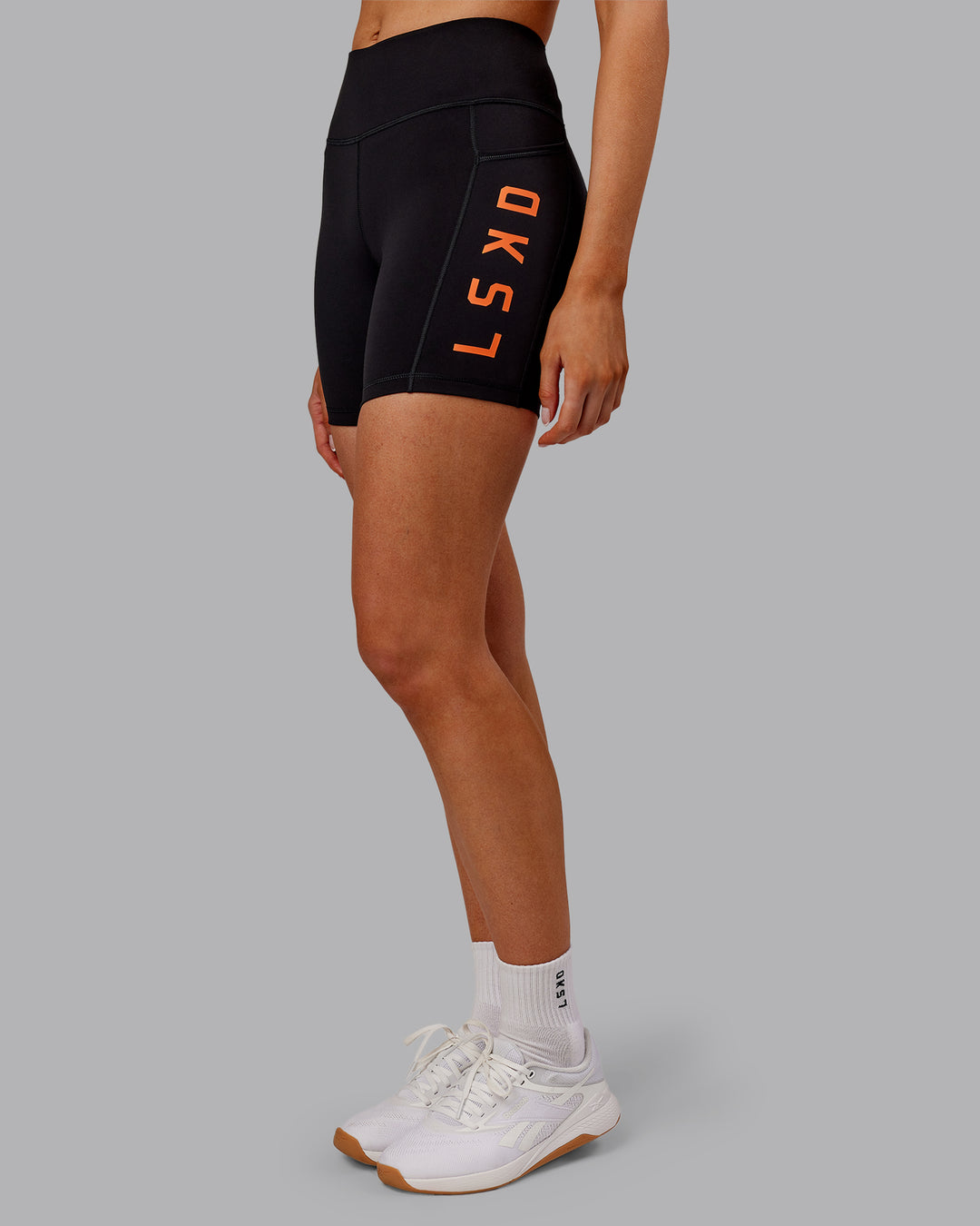 Woman wearing Rep Ultra High-Rise 6" Short Pockets - Black-Ultra Orange | Model:Ella | Size:S - view 3