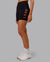 Woman wearing Rep Ultra High-Rise 6" Short Pockets - Black-Ultra Orange | Model:Ella | Size:S | Thumbnail Index: 2