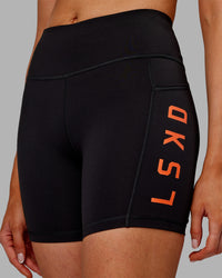 Woman wearing Rep Ultra High-Rise 6" Short Pockets - Black-Ultra Orange | Model:Ella | Size:S | Thumbnail Index: 5
