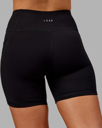 Woman wearing Rep Ultra High-Rise 6" Short Pockets - Black-Ultra Orange | Model:Ella | Size:S | Thumbnail Index: 7