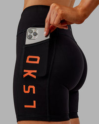 Woman wearing Rep Ultra High-Rise 6" Short Pockets - Black-Ultra Orange | Model:Ella | Size:S | Thumbnail Index: 0