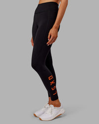 Woman wearing Rep Ultra High-Rise 7/8 Legging Pockets - Black-Ultra Orange | Model:Ella | Size:S | Thumbnail Index: 2