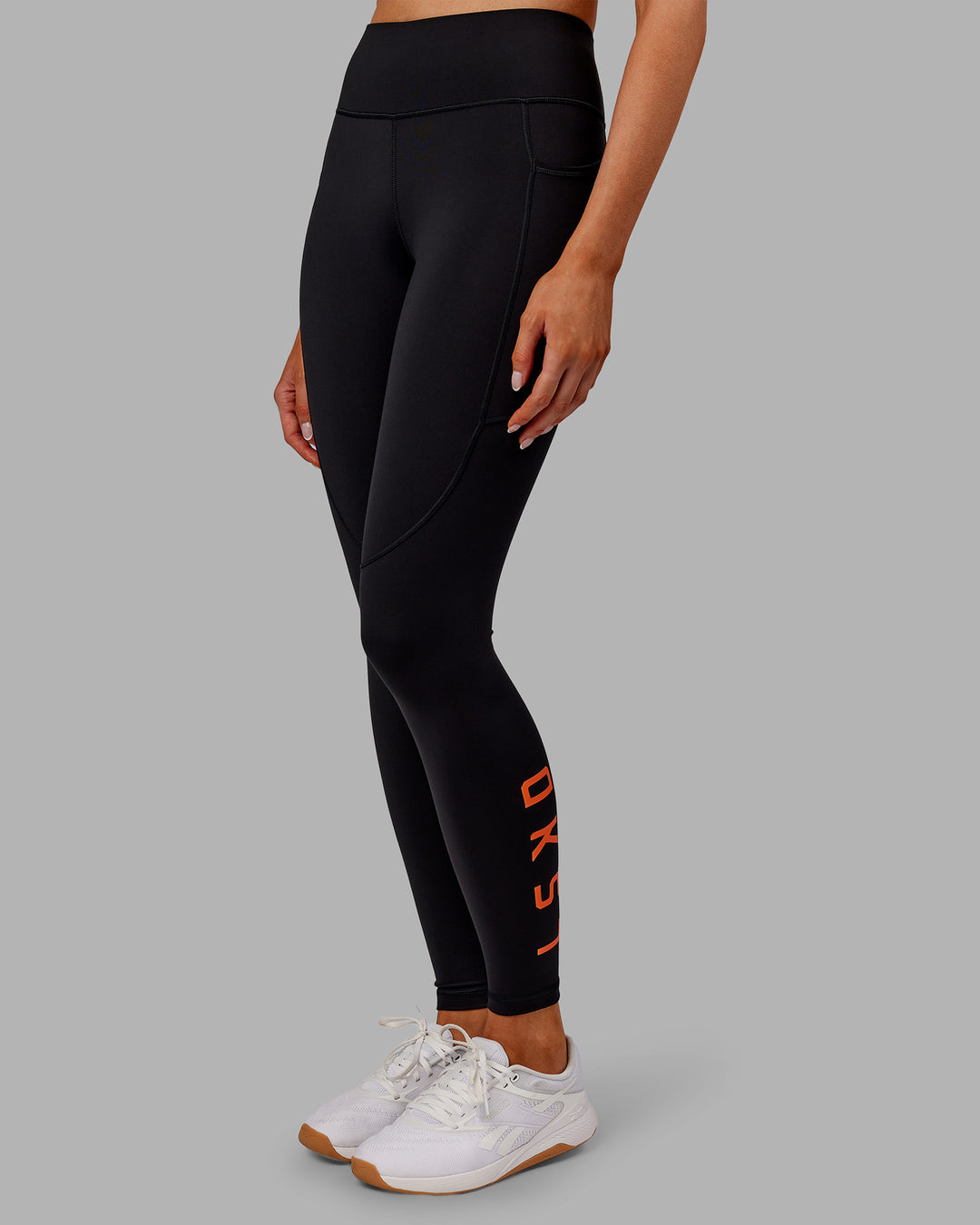 Woman wearing Rep Ultra High-Rise Full Length Legging Pockets - Black-Ultra Orange | Model:Ella | Size:S - view 1
