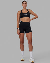 Women wearing O.G. Rep Ultra High-Rise 4" Short Pockets - Black-White | Model:Shae | Size:S | Thumbnail Index: 2