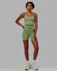 Woman wearing Resistance Ribbed Shelf Bra Performance Tank - Bayleaf | Thumbnail Index: 6