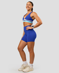 Woman wearing Revitalise Flash Sports Bra - Electric Indigo-Multi | Model:Summer | Size:S | Thumbnail Index: 2