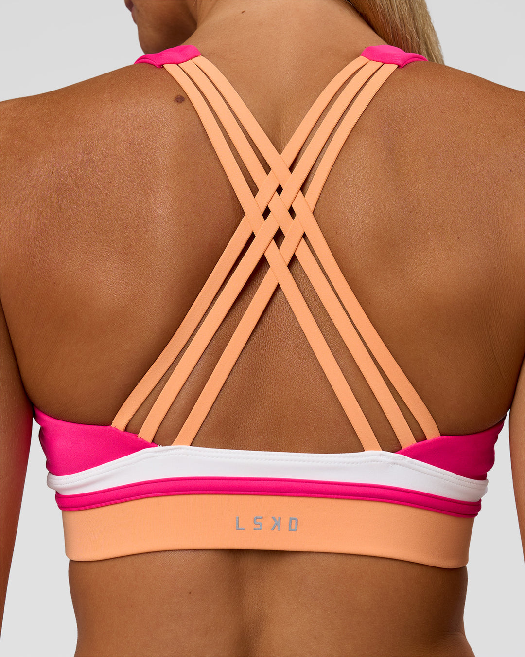 Woman wearing Revitalise Flash Sports Bra - Ultra Pink-Cantaloupe-White | Model:Amity | Size:S - view 4