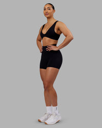 Woman wearing Rhythm Elixir Ultra High-Rise 4" Short - Black | Model:Ayla | Size:S | Thumbnail Index: 1