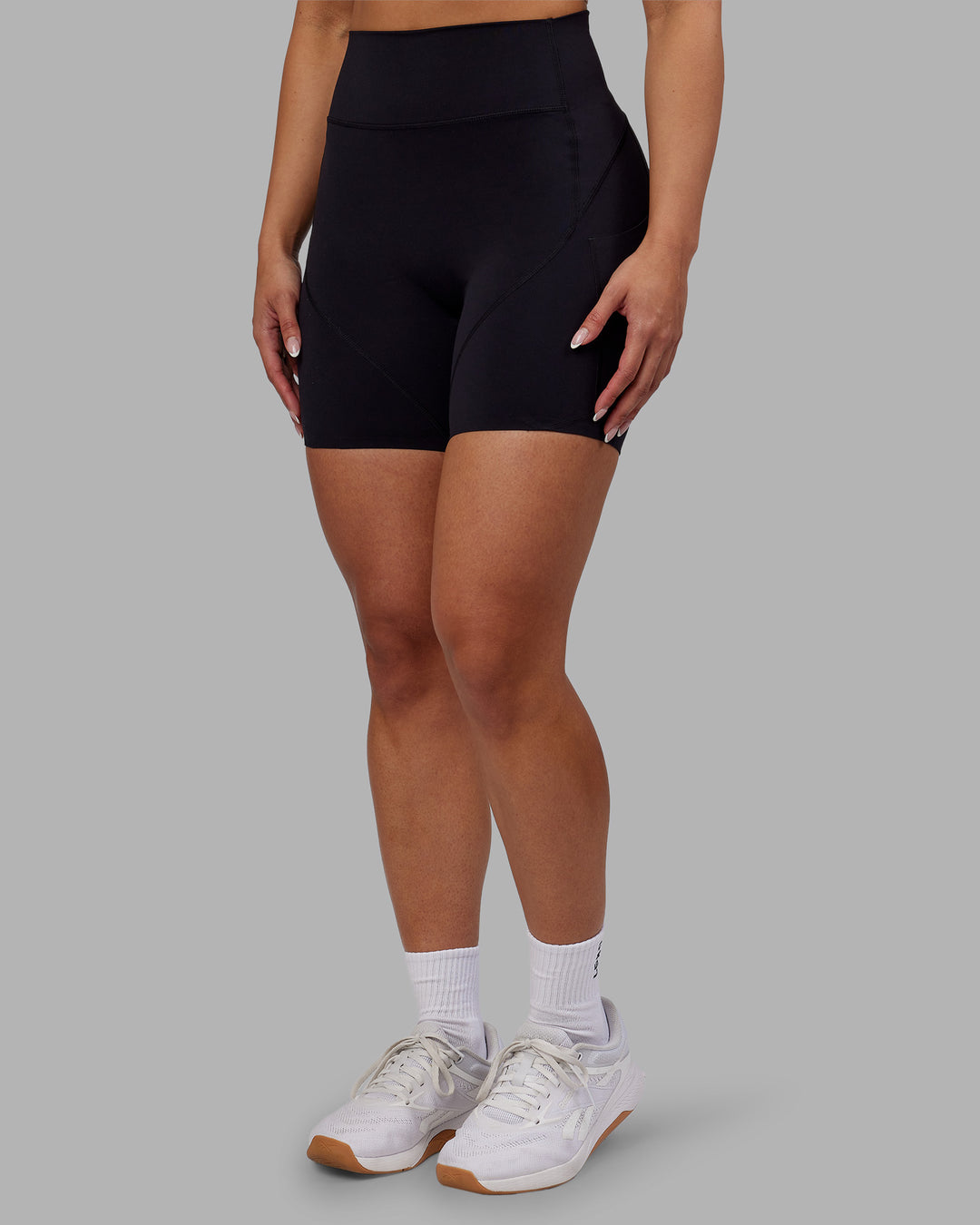 Woman wearing Rhythm Elixir Ultra High-Rise 6" Short Pockets - Black | Model:Ayla | Size:S - view 1