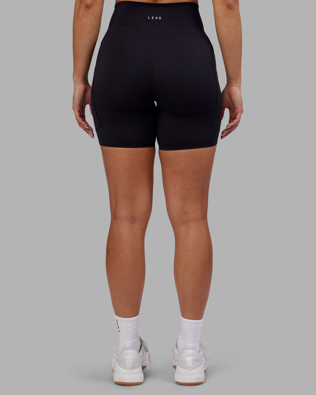 Woman wearing Rhythm Elixir Ultra High-Rise 6" Short Pockets - Black | Model:Ayla | Size:S - view 5