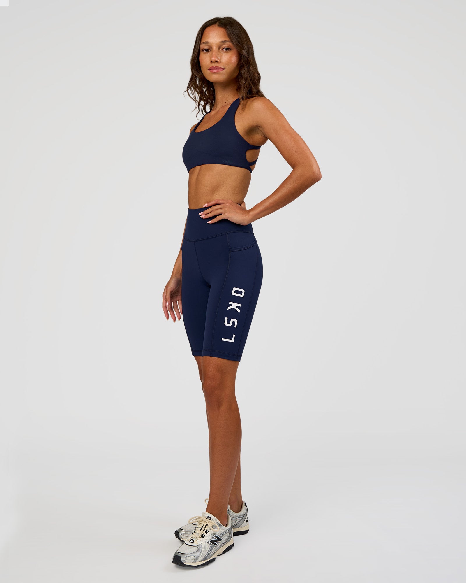 Woman wearing Rep Ultra High-Rise 9" Short Pockets - Future Navy-White | Model:Dakota | Size:S