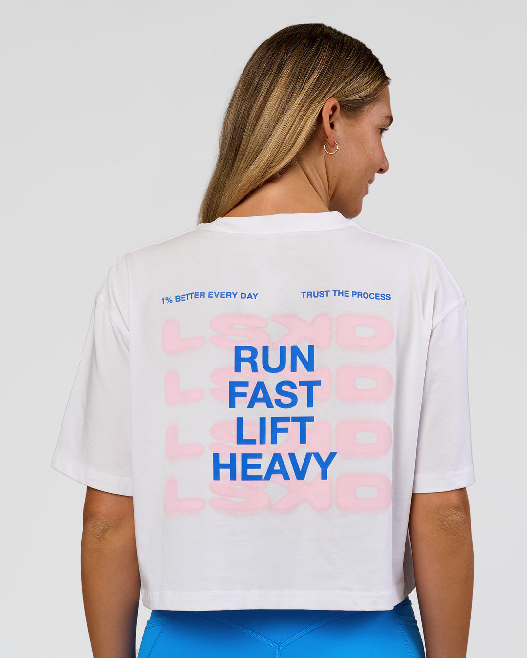 Woman wearing Run Fast Lift Heavy FLXCotton Cropped Tee - White | Model:Amity | Size:S - view 1