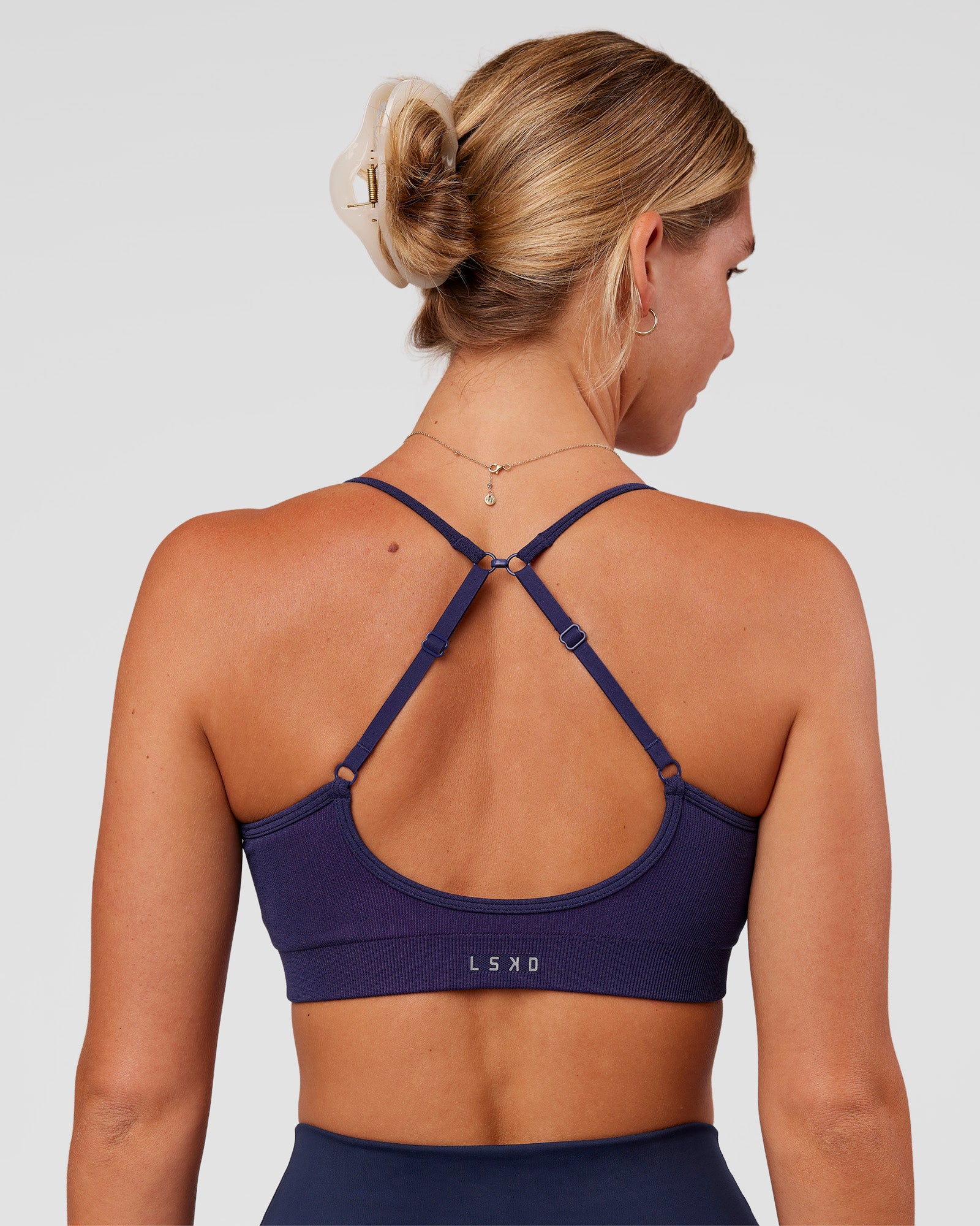 Woman wearing Spark Seamless Ribbed Sports Bra - Future Navy-Ultra Fuchsia | Model:Amity | Size:S