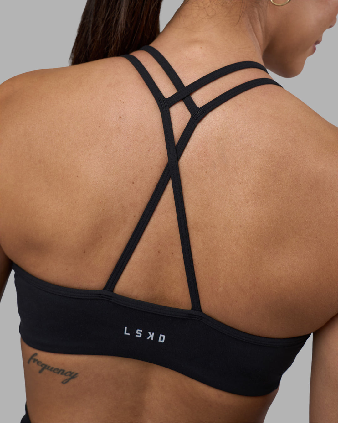 Woman wearing Stamina Pulse Sports Bra - Black | Model:Rhiley | Size:S - view 1