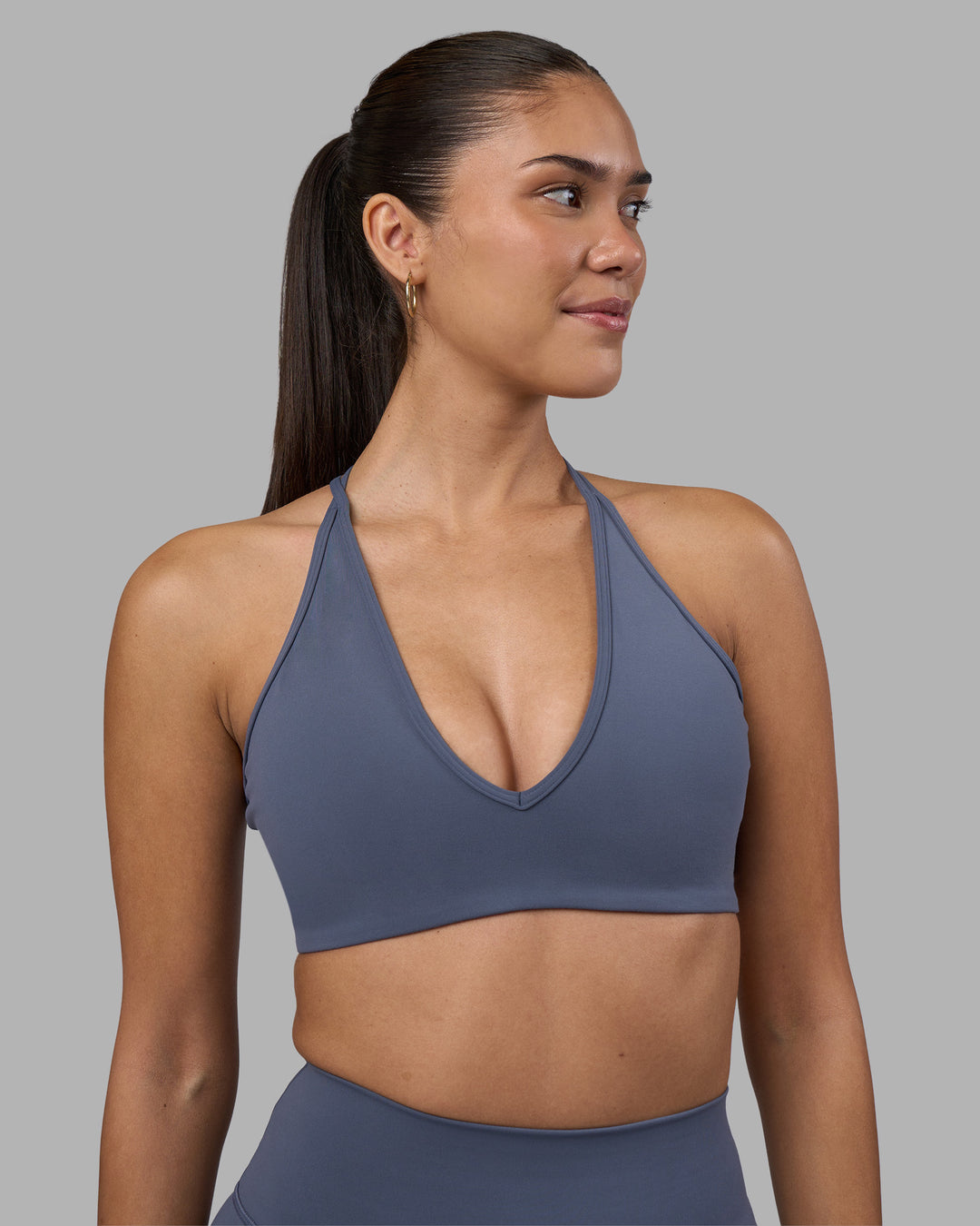 Woman wearing Stamina Pulse Sports Bra - Night Shadow | Model:Rhiley | Size:S - view 1