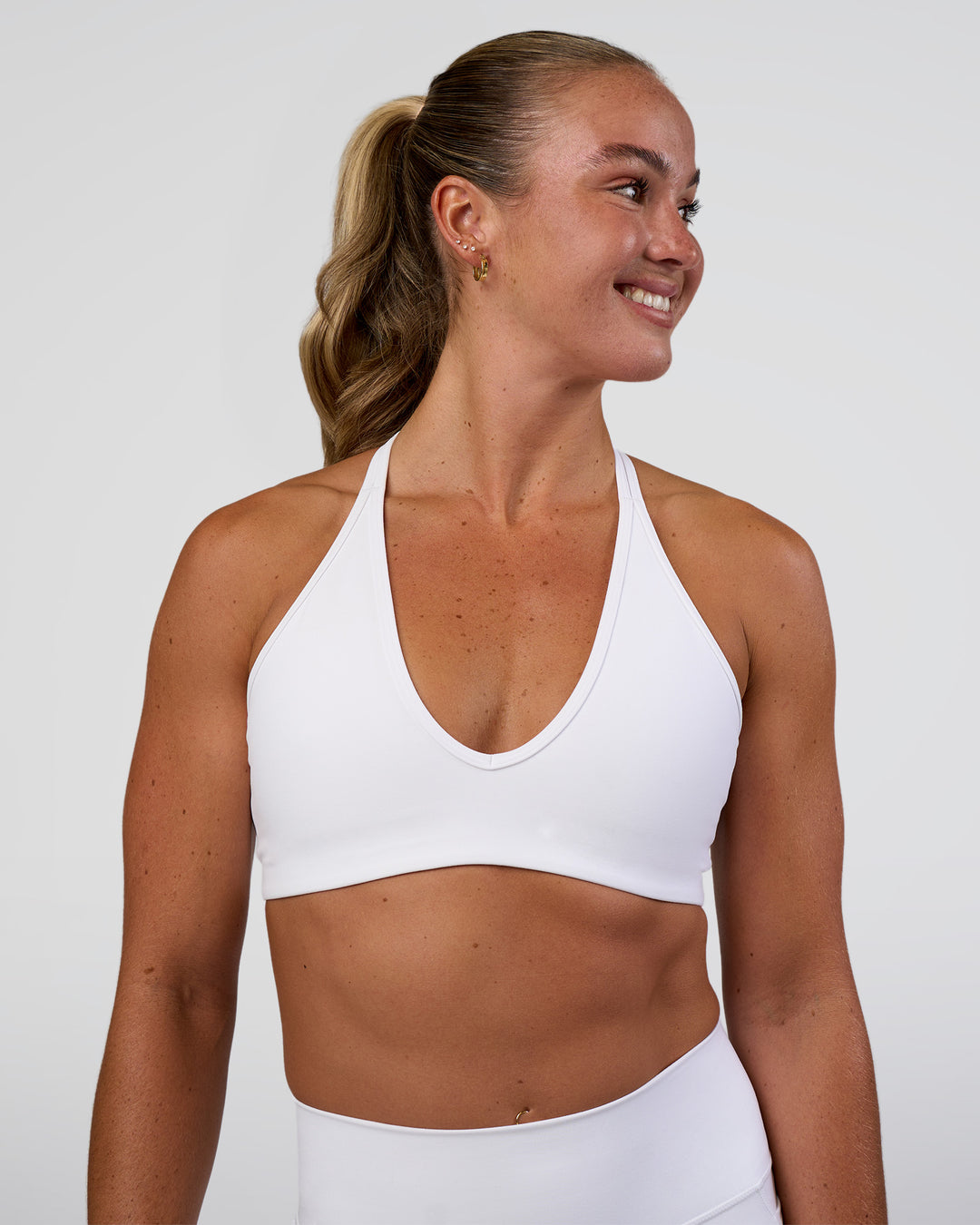Woman wearing Stamina Pulse Sports Bra - White | Model:Sav | Size:S - view 1