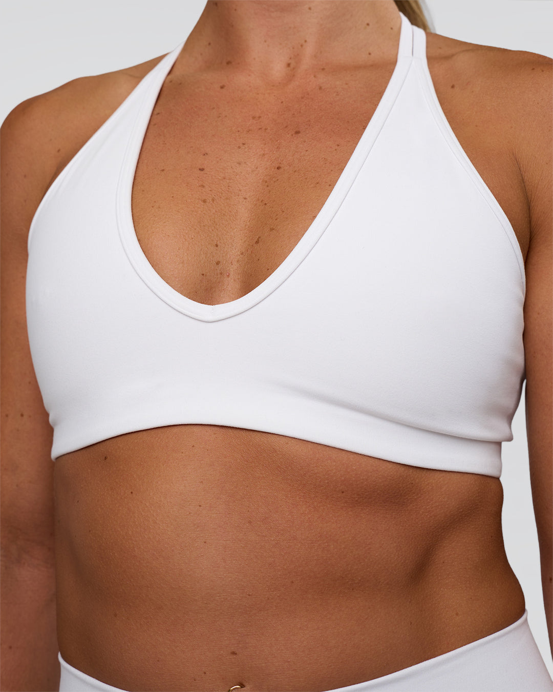 Woman wearing Stamina Pulse Sports Bra - White | Model:Sav | Size:S - view 4