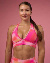 Woman wearing Stamina Rise Sports Bra - Pink Glow Print | Model:Hannah | Size:S | Thumbnail Index: 1