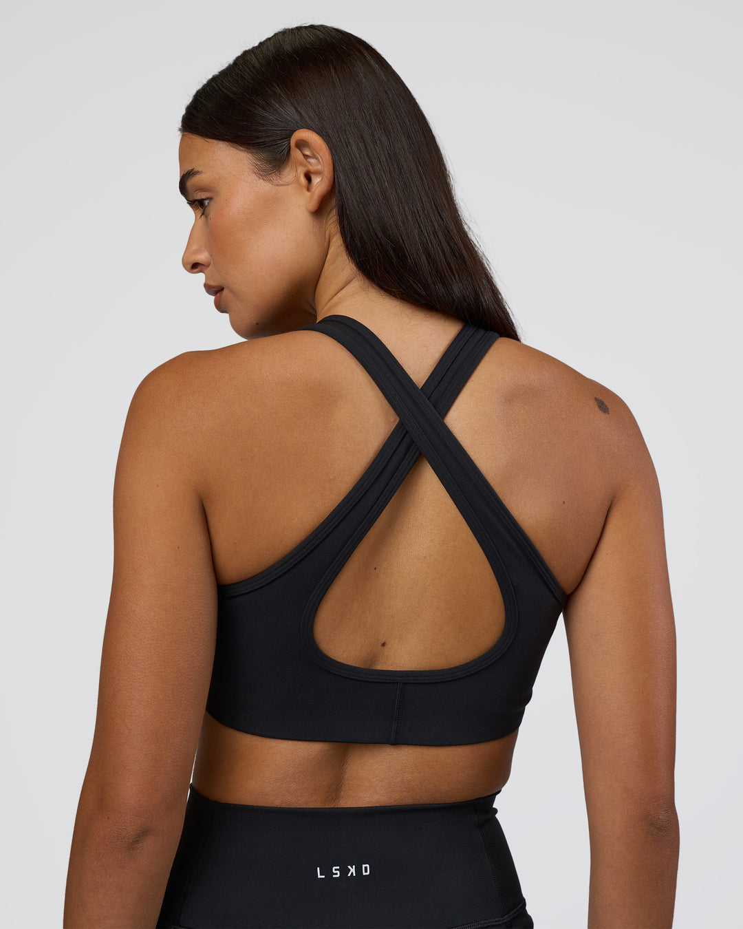 Woman wearing Stamina Sports Bra - Black | Set:true | Angle:back | Model:Ruby | Size:S - view 2