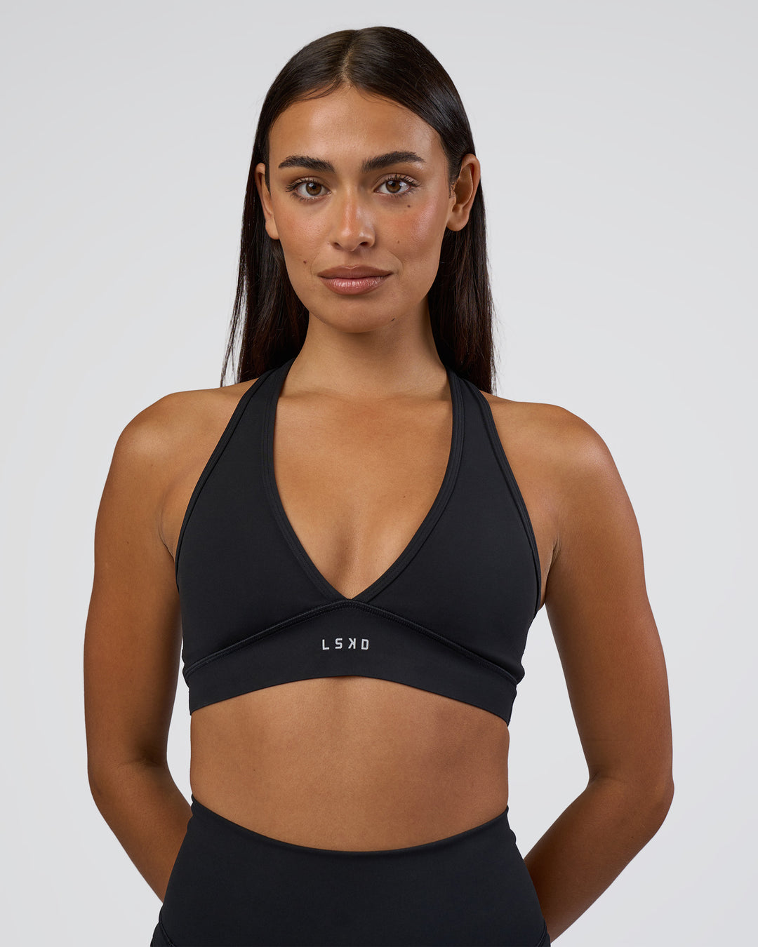 Woman wearing Stamina Sports Bra - Black | Set:true | Angle:front | Model:Ruby | Size:S - view 3