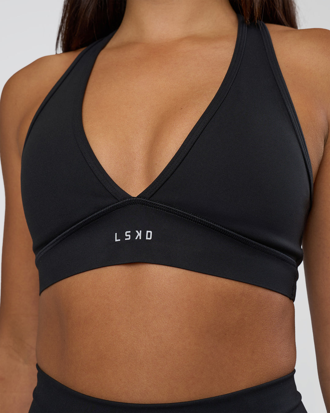 Woman wearing Stamina Sports Bra - Black | Set:true | Angle:closeup | Model:Ruby | Size:S - view 5