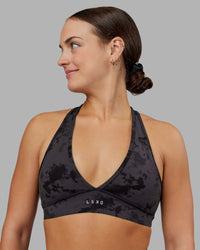 Woman wearing Stamina Sports Bra - Black Tie Dye | Set:true | Angle:front | Model:Keisha | Size:S | Thumbnail Index: 0