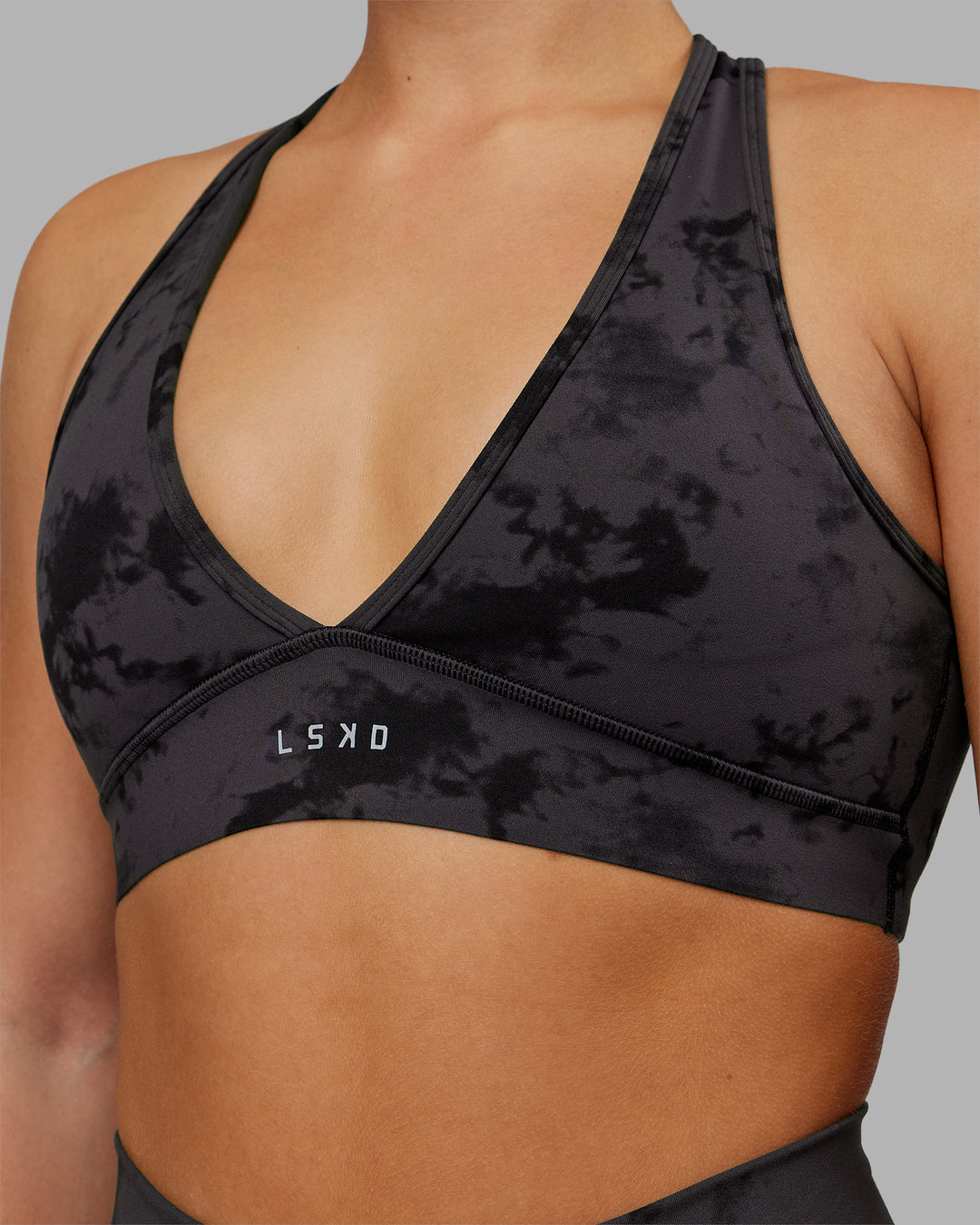 Woman wearing Stamina Sports Bra - Black Tie Dye | Set:true | Angle:closeup | Model:Keisha | Size:S - view 6