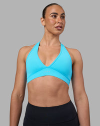 Woman wearing Stamina Sports Bra - Blue Atoll | Set:true | Angle:front | Model:Sophie | Size:S | Thumbnail Index: 0