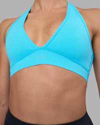 Woman wearing Stamina Sports Bra - Blue Atoll | Set:true | Angle:closeup | Model:Sophie | Size:S | Thumbnail Index: 3