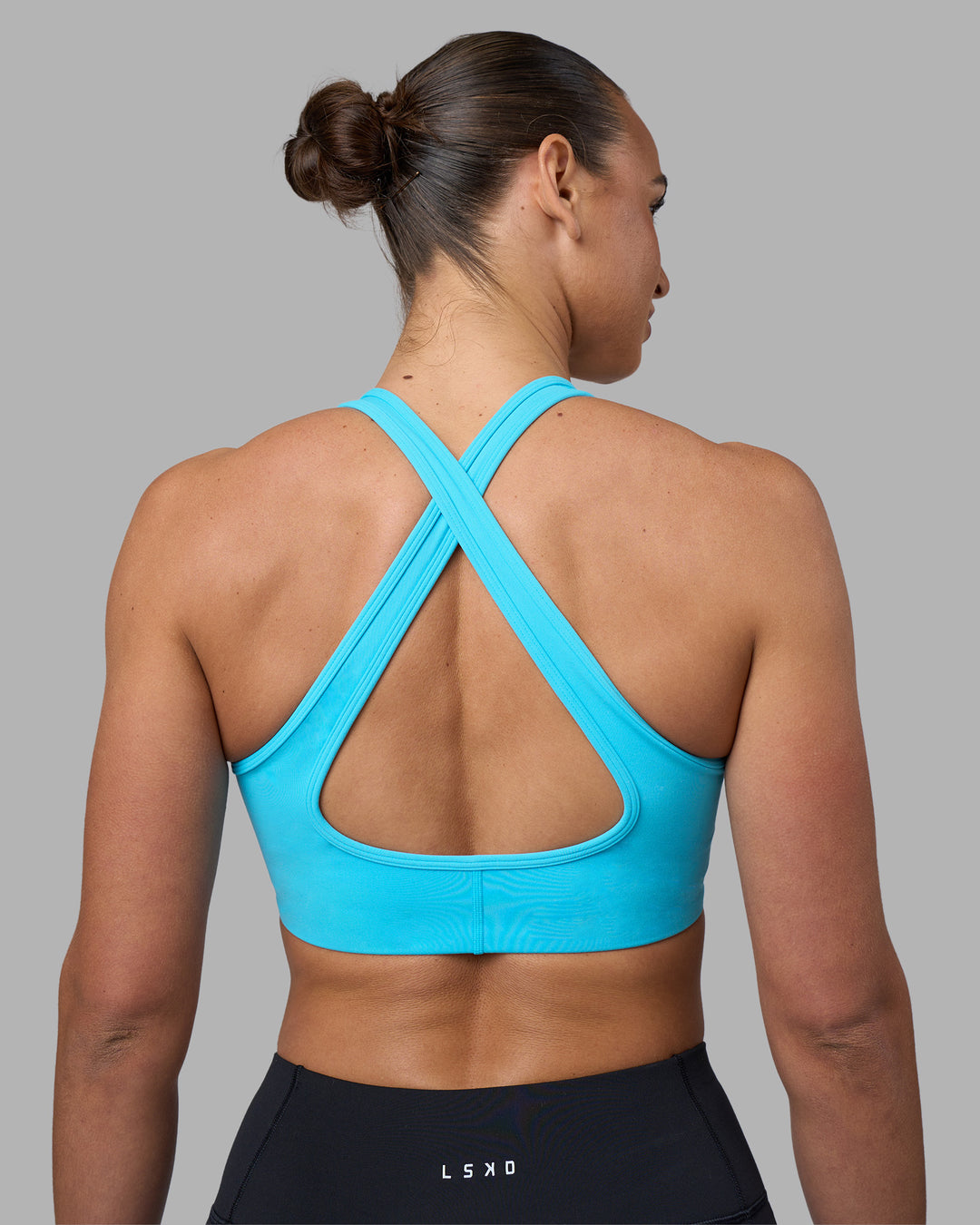 Woman wearing Stamina Sports Bra - Blue Atoll | Set:true | Angle:back | Model:Sophie | Size:S - view 5