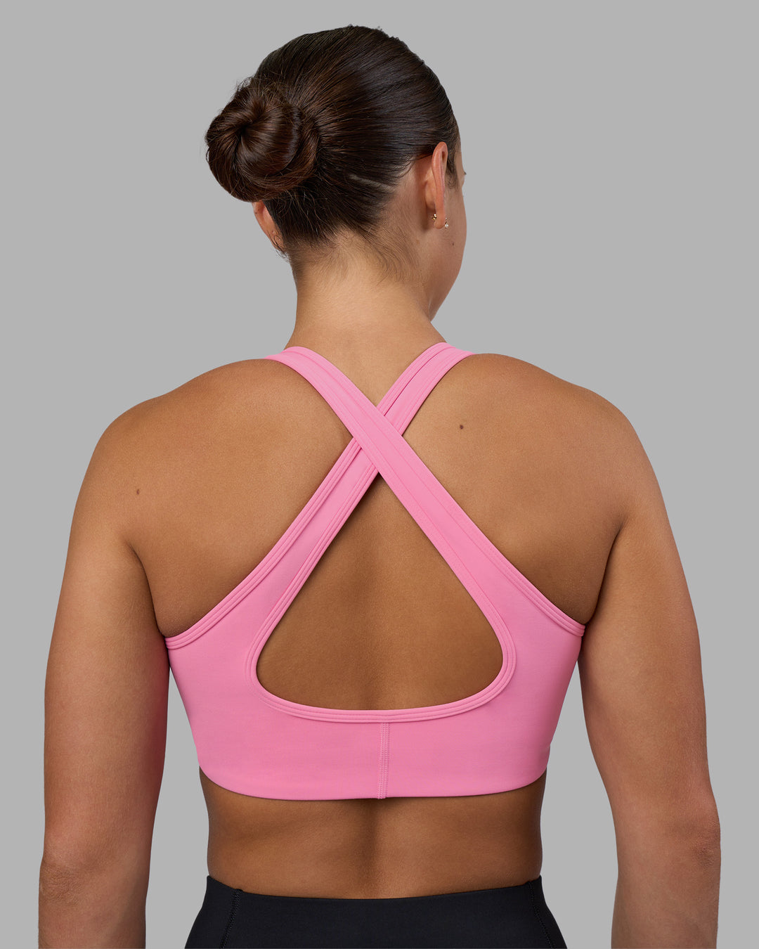 Woman wearing Stamina Sports Bra - Candy Pink | Set:true | Angle:back | Model:Keisha | Size:S - view 2