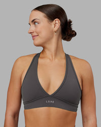Woman wearing Stamina Sports Bra - Dark Storm | Set:true | Angle:front | Model:Keisha | Size:S | Thumbnail Index: 0