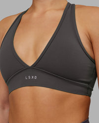 Woman wearing Stamina Sports Bra - Dark Storm | Set:true | Angle:closeup | Model:Keisha | Size:S | Thumbnail Index: 5