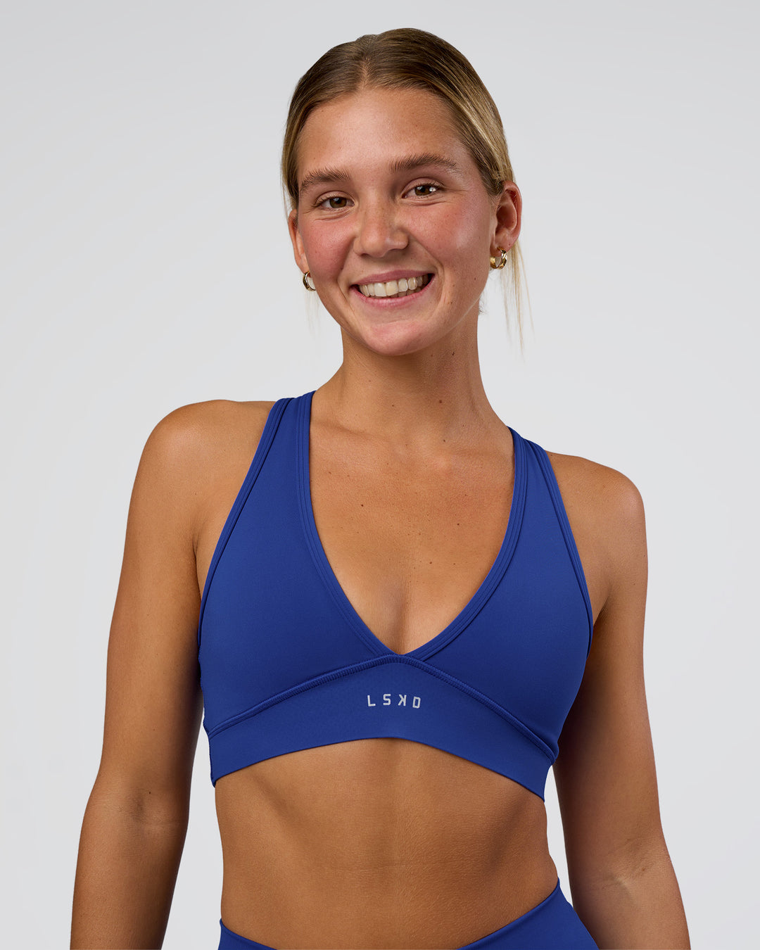 Woman wearing Stamina Sports Bra - Electric Indigo | Set:true | Angle:front | Model:Amity | Size:S - view 2