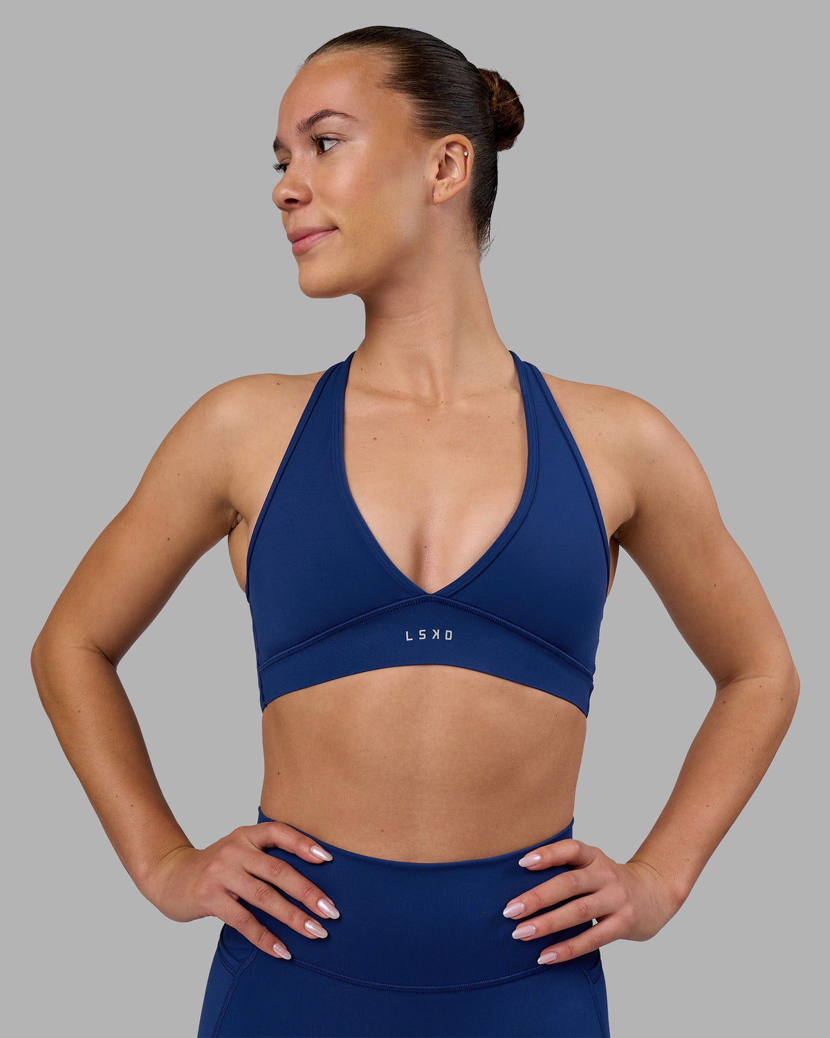 Woman wearing Stamina Sports Bra - Midnight Blue | Set:true | Angle:front | Model:Charlize | Size:S