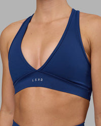 Woman wearing Stamina Sports Bra - Midnight Blue | Set:true | Angle:closeup | Model:Charlize | Size:S | Thumbnail Index: 3