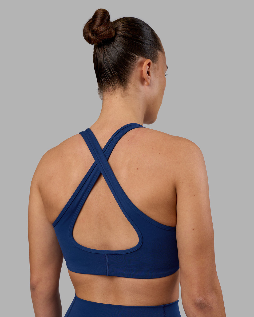 Woman wearing Stamina Sports Bra - Midnight Blue | Set:true | Angle:back | Model:Charlize | Size:S - view 2