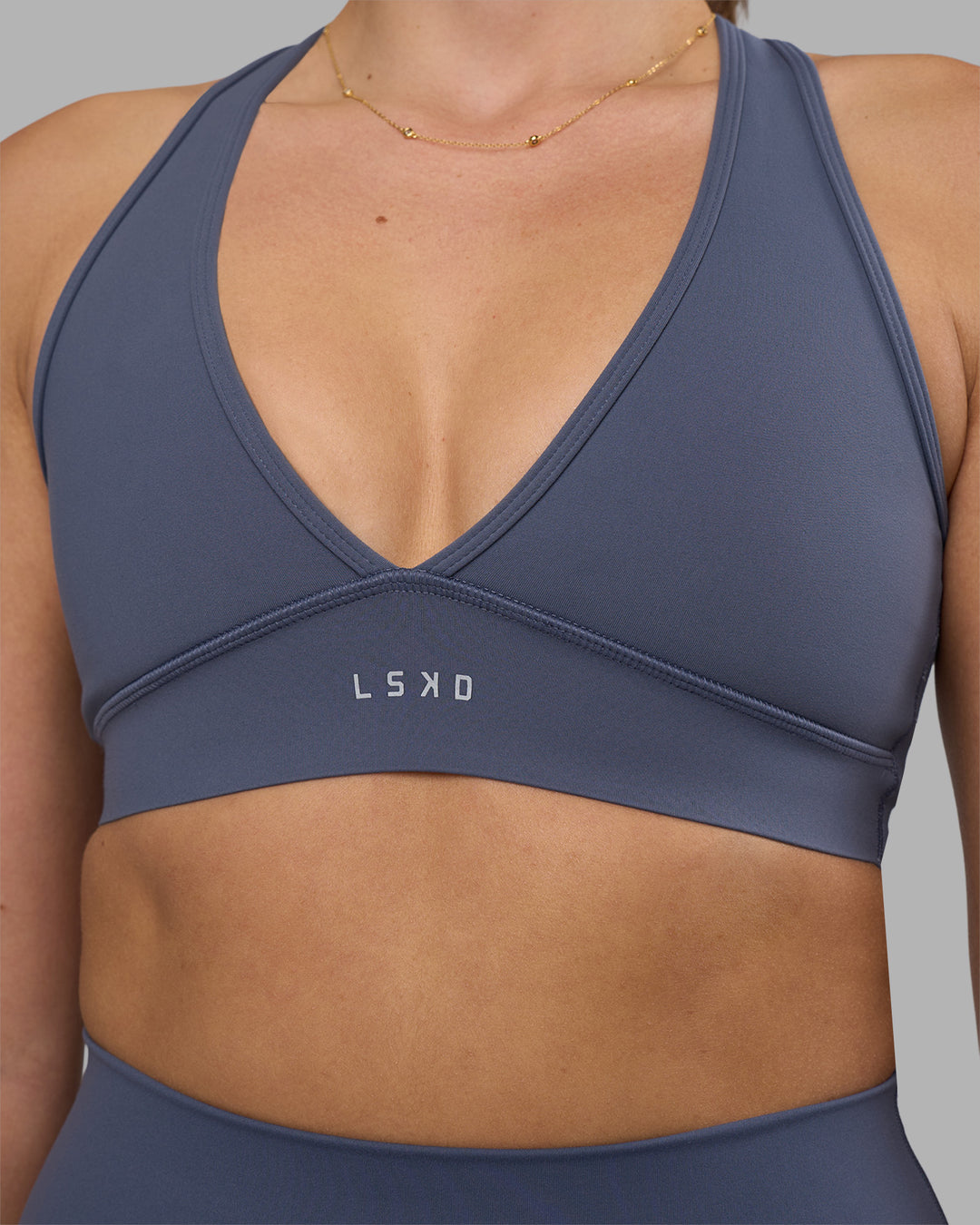 Woman wearing Stamina Sports Bra - Night Shadow | Set:true | Angle:closeup | Model:Phoebe | Size:S - view 6