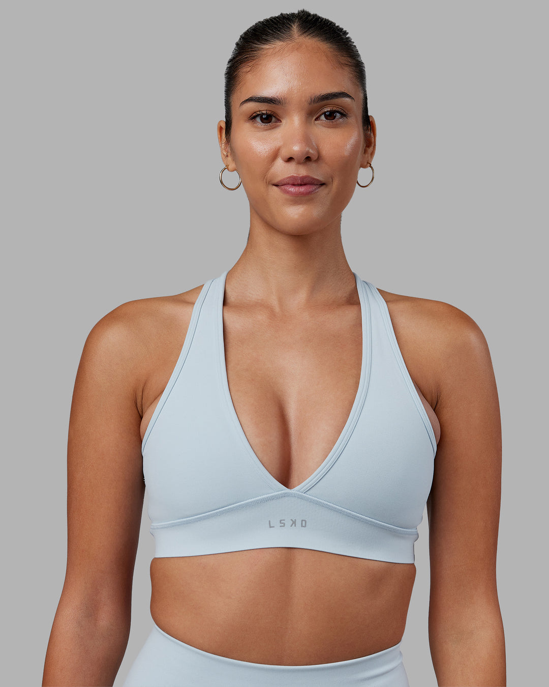 Woman wearing Stamina Sports Bra - Skyride | Set:true | Angle:front | Model:Rhiley | Size:S - view 1