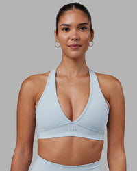 Woman wearing Stamina Sports Bra - Skyride | Set:true | Angle:front | Model:Rhiley | Size:S | Thumbnail Index: 0