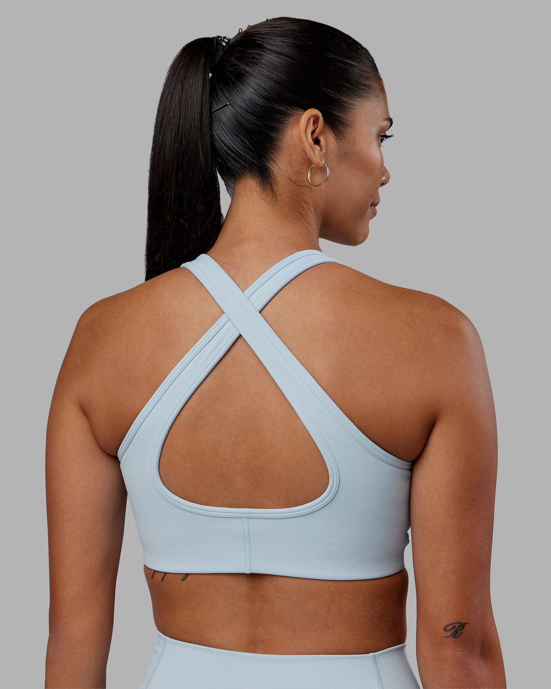 Woman wearing Stamina Sports Bra - Skyride | Set:true | Angle:back | Model:Rhiley | Size:S - view 4