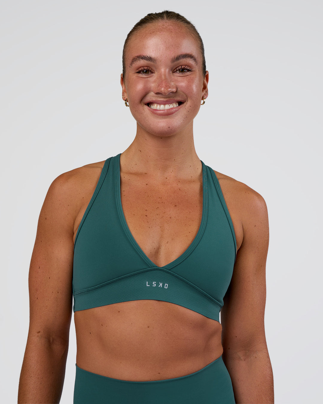 Woman wearing Stamina Sports Bra - Transformative Teal | Set:true | Angle:front | Model:Sav | Size:S - view 1