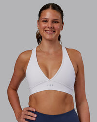 Woman wearing Stamina Sports Bra - White | Set:true | Angle:front | Model:Phoebe | Size:S | Thumbnail Index: 0