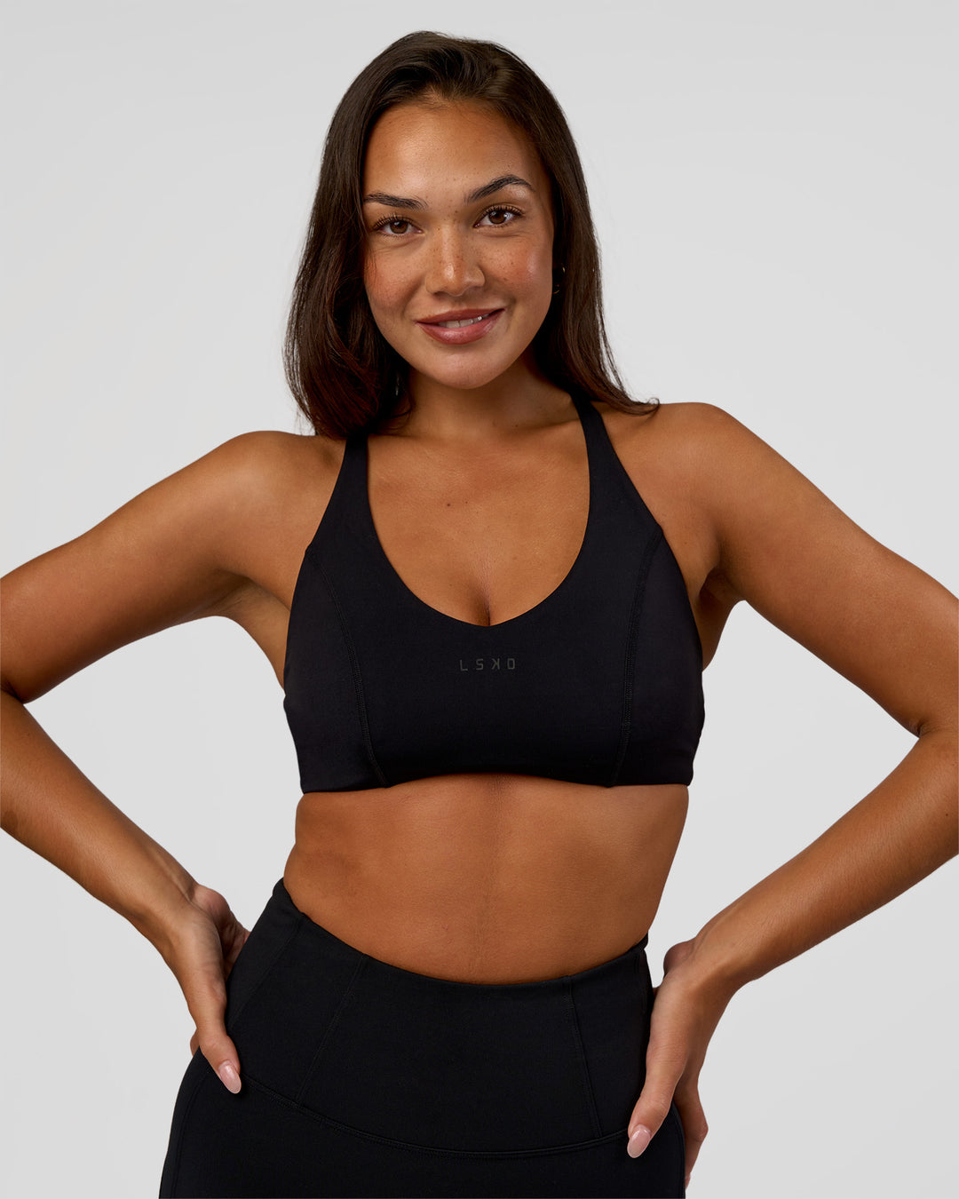 Woman wearing Stellar Sports Bra - Black | Model:Kirstyn | Size:S - view 2